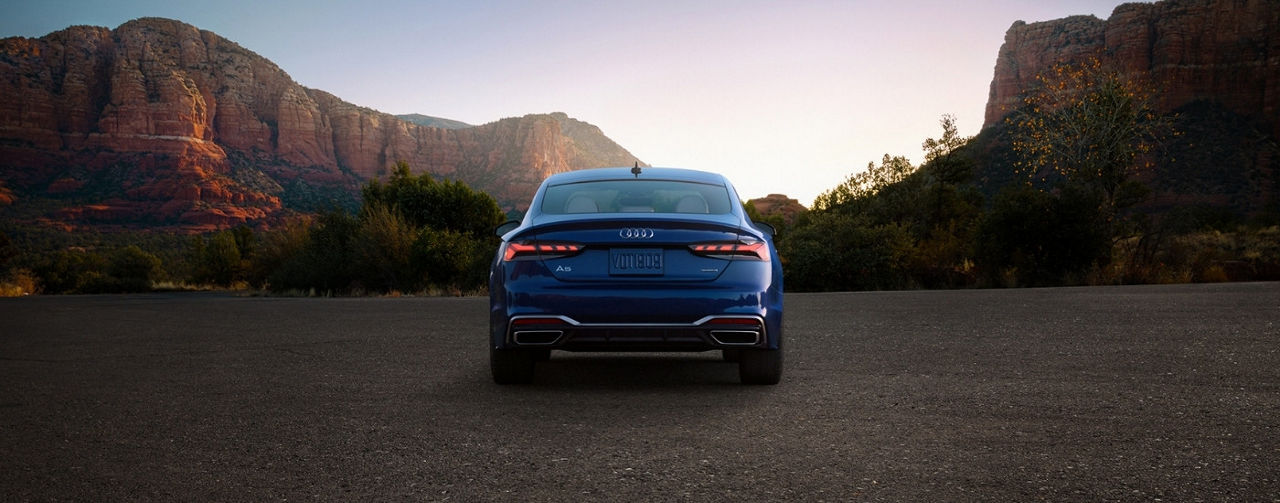 A black 2025 Audi A5 parked at dusk.